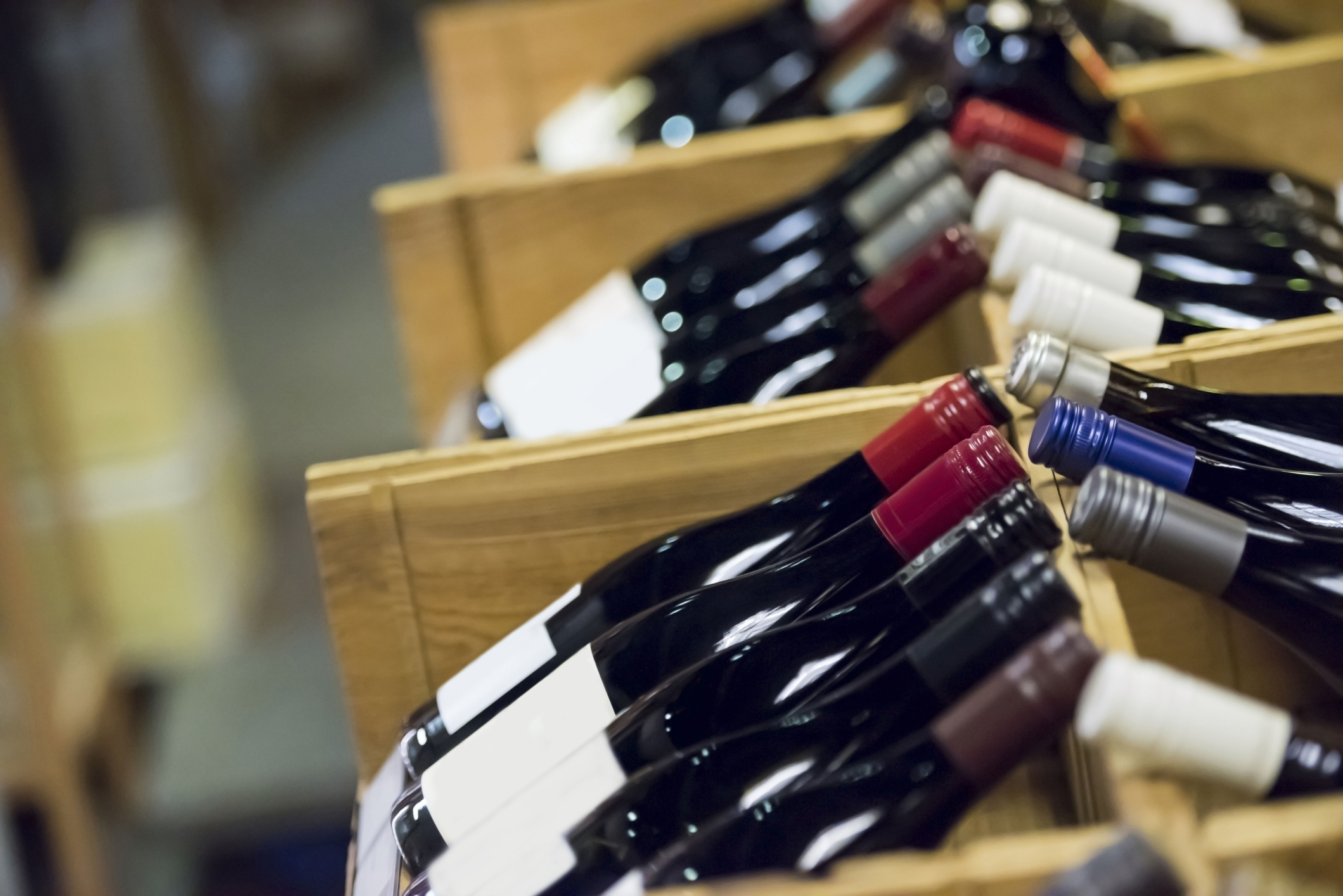 Bottles of red wine on display in a store