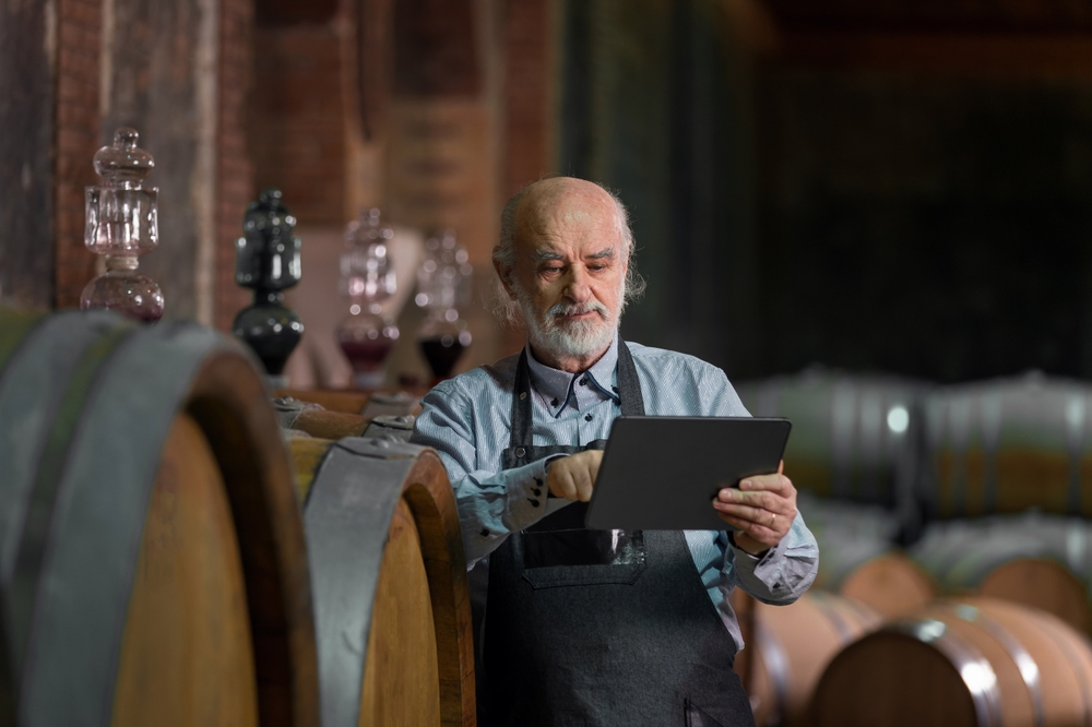 Caucasian,Senior,Man,,A,Graybeard,Winemaker,With,Apron,Checking,Big