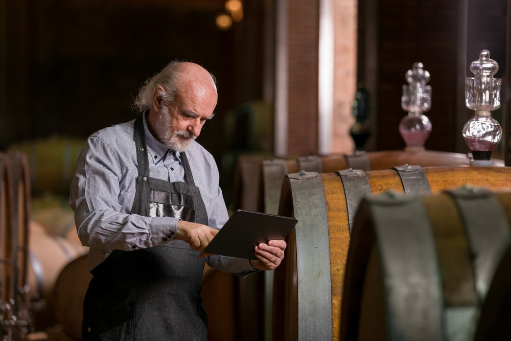 Caucasian,Experienced,Winemaker,Checking,A,Wine,Aging,In,Barrels,Data,